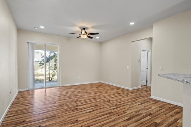 unfurnished room with ceiling fan and wood-type flooring