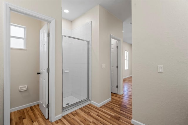 bathroom featuring hardwood / wood-style floors and an enclosed shower