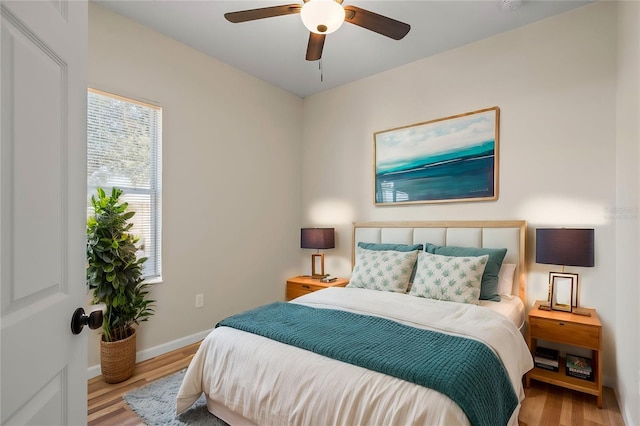 bedroom with light hardwood / wood-style floors and ceiling fan