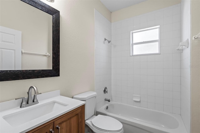 full bathroom featuring tiled shower / bath, vanity, and toilet