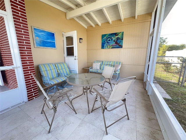 sunroom with beam ceiling