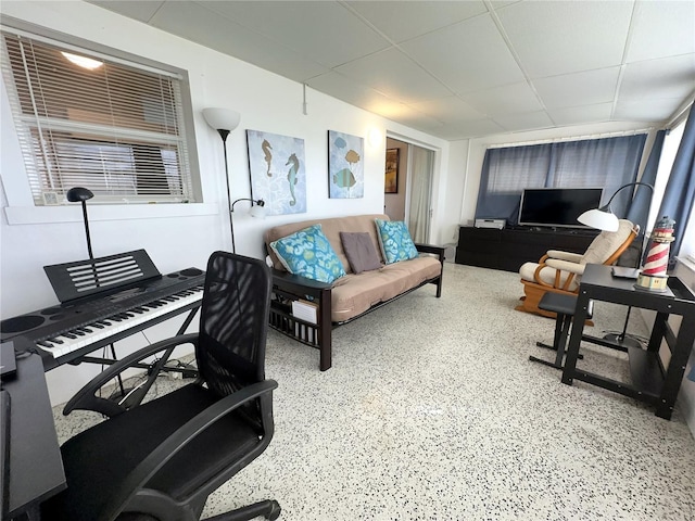 office area with speckled floor and a drop ceiling