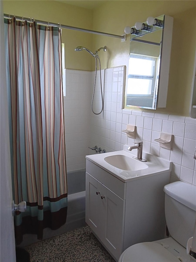 full bath featuring toilet, shower / bath combination with curtain, tile walls, and vanity