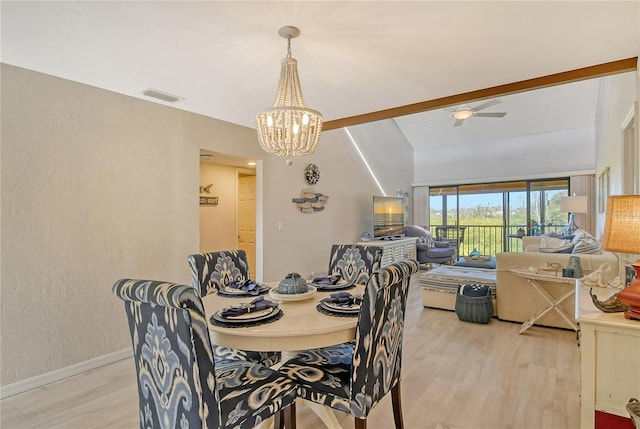 dining area featuring light wood finished floors, baseboards, visible vents, a textured wall, and ceiling fan with notable chandelier