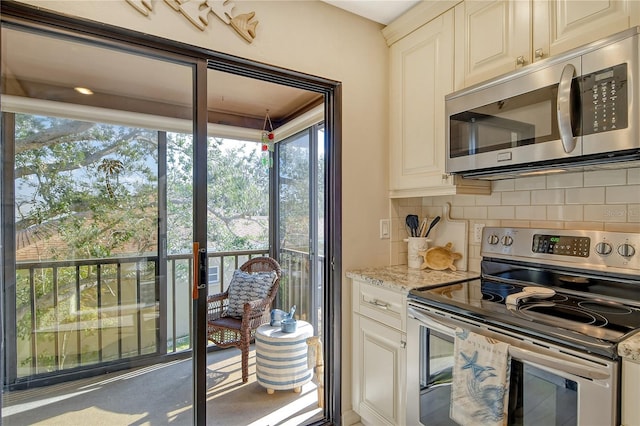 kitchen with appliances with stainless steel finishes, backsplash, and light stone countertops