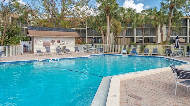 pool featuring a patio area and fence