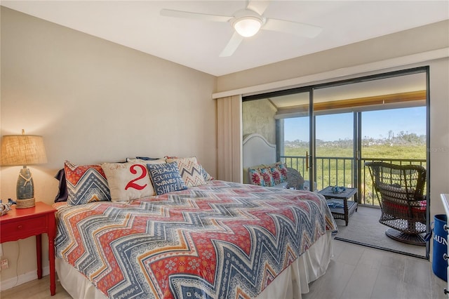 bedroom with access to exterior, a ceiling fan, and wood finished floors