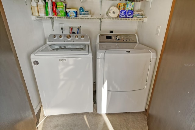 laundry room featuring washing machine and dryer, laundry area, and carpet