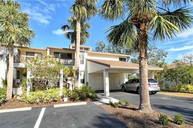 view of property featuring uncovered parking