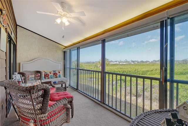 sunroom featuring vaulted ceiling and ceiling fan