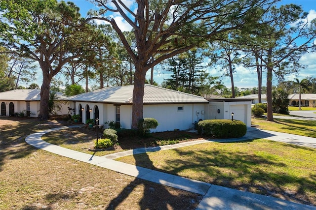 view of front of property featuring a garage and a front yard