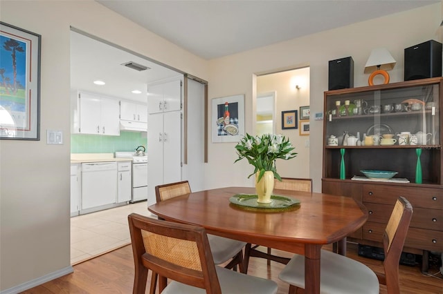 dining space with light hardwood / wood-style floors