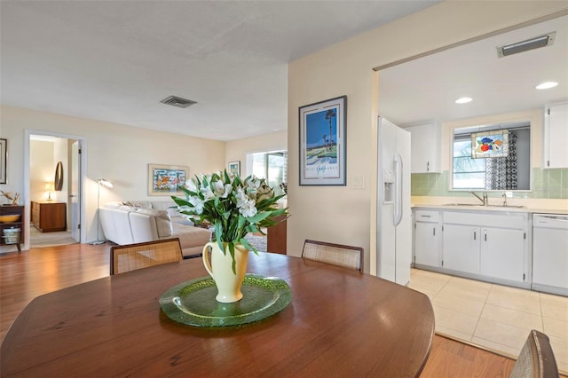 dining space featuring sink and light hardwood / wood-style flooring