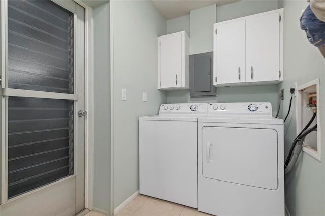 washroom featuring light tile patterned flooring, cabinets, independent washer and dryer, and electric panel