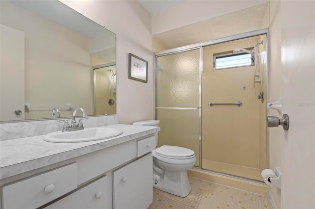 bathroom featuring tile patterned flooring, vanity, toilet, and walk in shower