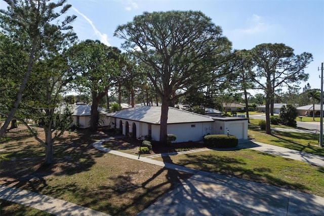 view of home's exterior with a garage and a yard