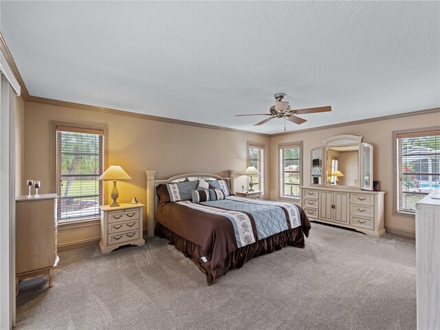 bedroom featuring baseboards, ceiling fan, carpet, and crown molding