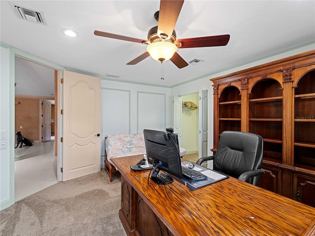 office featuring light colored carpet, visible vents, and ceiling fan