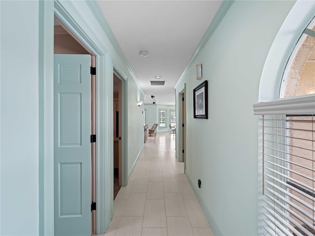 hall featuring ornamental molding and baseboards