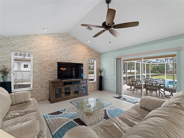 living area featuring lofted ceiling, a sunroom, a healthy amount of sunlight, and tile patterned floors