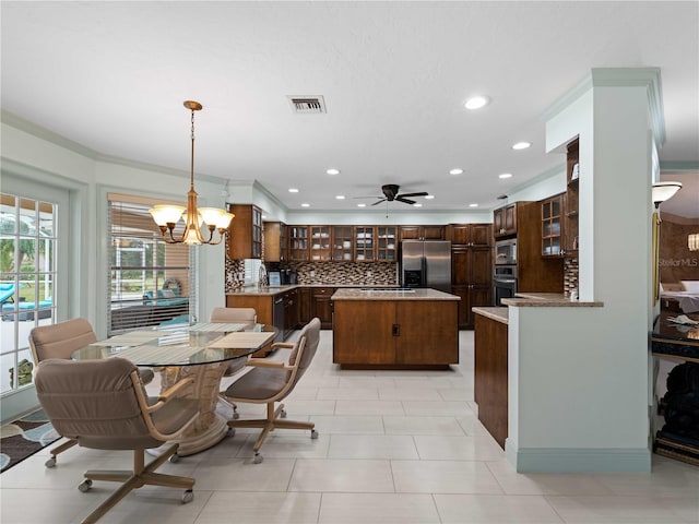 dining area featuring recessed lighting, ceiling fan with notable chandelier, visible vents, and ornamental molding