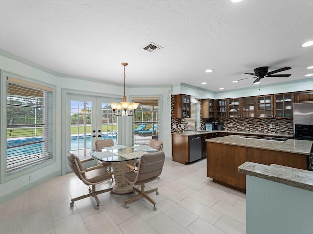 kitchen with black dishwasher, visible vents, decorative backsplash, glass insert cabinets, and a kitchen island