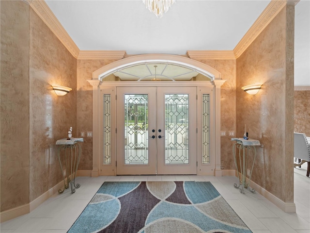 foyer entrance with ornamental molding, tile patterned flooring, french doors, and baseboards