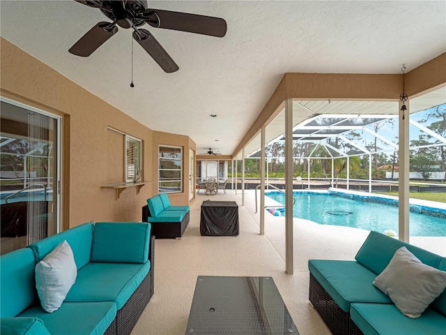 exterior space with glass enclosure, an outdoor hangout area, a ceiling fan, and a patio