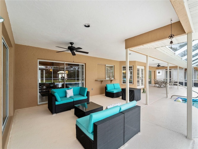 view of patio featuring outdoor dining area, a lanai, an outdoor living space, a ceiling fan, and french doors