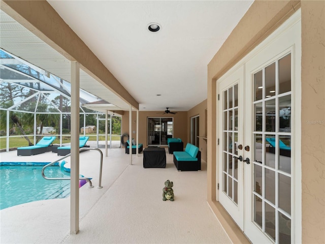 pool with ceiling fan, french doors, a patio area, and a lanai