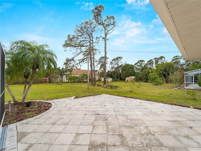 view of patio featuring glass enclosure