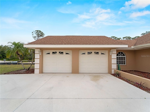 garage with concrete driveway