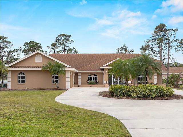 ranch-style house featuring concrete driveway, a front lawn, and stucco siding