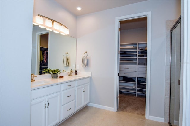 bathroom with tile patterned floors, vanity, and a shower with shower door