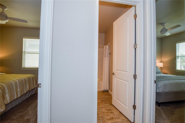 bedroom with ceiling fan and light colored carpet