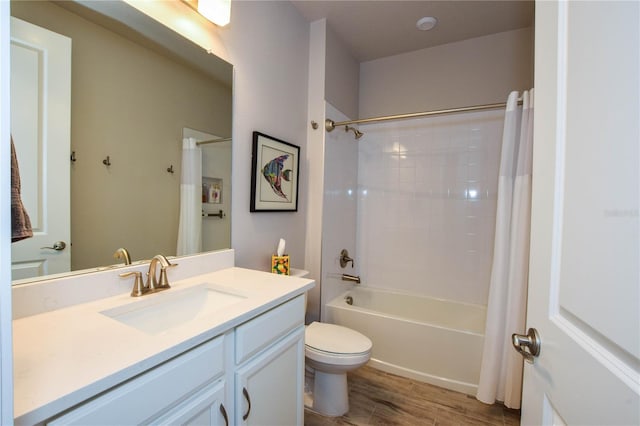 full bathroom with vanity, hardwood / wood-style floors, shower / bath combination with curtain, and toilet