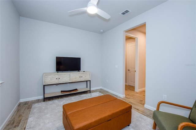 living room with ceiling fan and light wood-type flooring