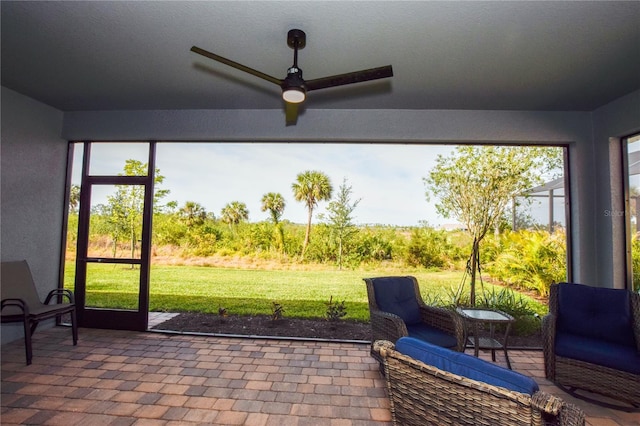 sunroom featuring ceiling fan