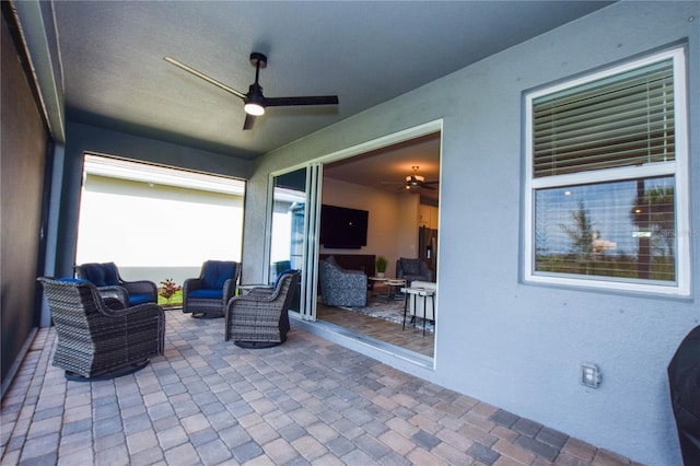 view of patio / terrace with an outdoor living space and ceiling fan