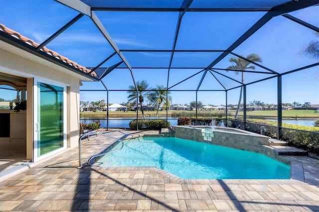 view of pool with an in ground hot tub, a water view, glass enclosure, and a patio