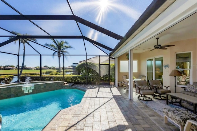 view of pool featuring ceiling fan, a lanai, pool water feature, and a patio area