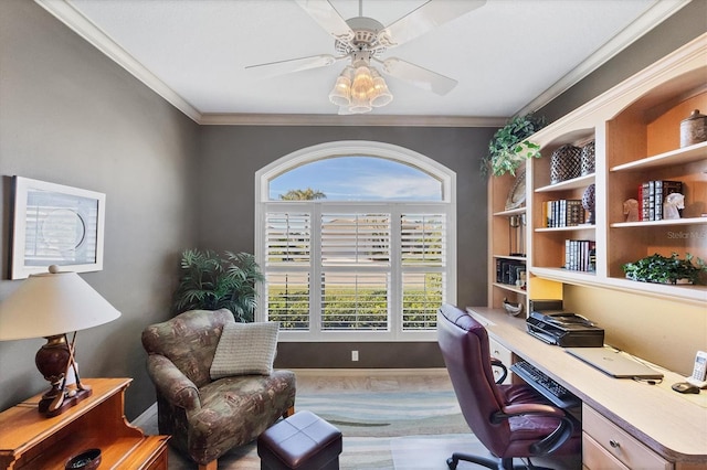 carpeted office with crown molding and ceiling fan