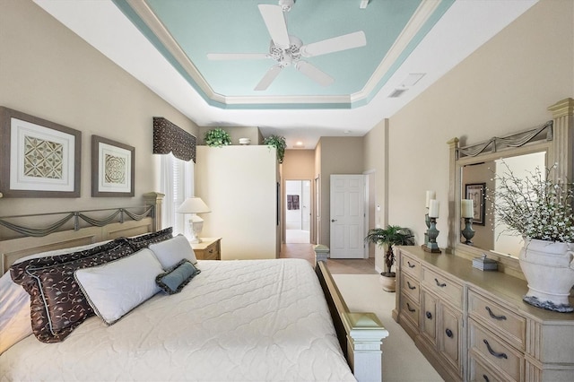 bedroom with light carpet, a raised ceiling, and ceiling fan