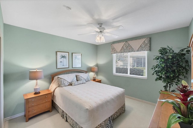 bedroom with light colored carpet and ceiling fan