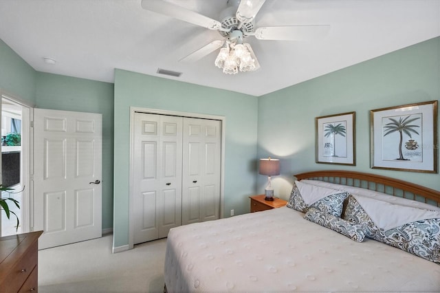 bedroom featuring light carpet, a closet, and ceiling fan