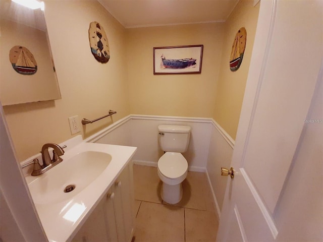 bathroom featuring tile patterned flooring, vanity, and toilet