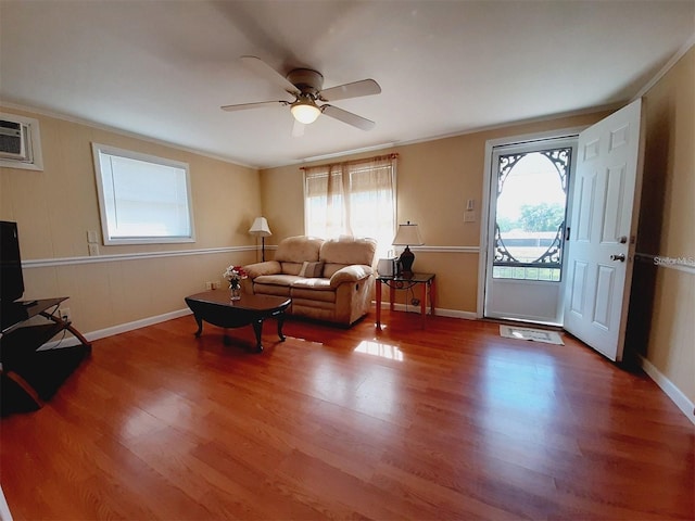 living room featuring crown molding, wood-type flooring, and ceiling fan