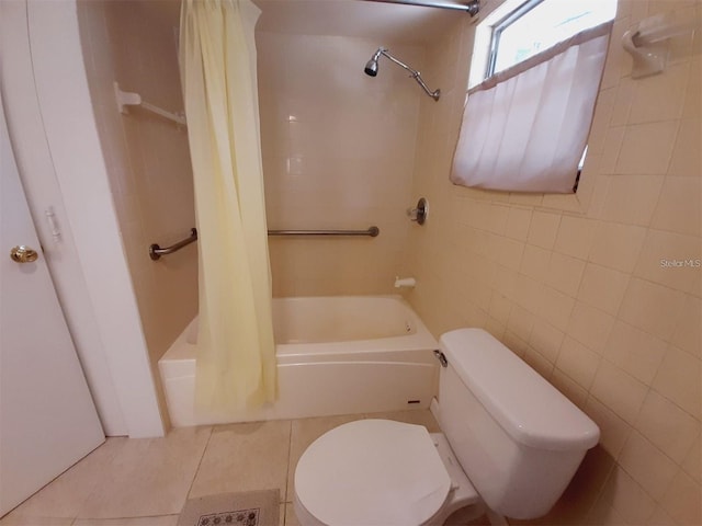 bathroom with tile patterned flooring, toilet, shower / bath combination with curtain, and tile walls