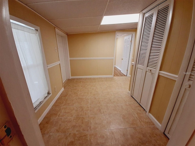 hallway featuring a paneled ceiling