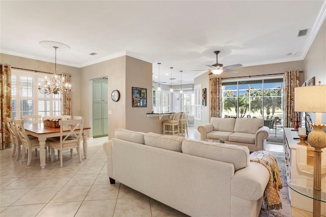 living area featuring ceiling fan with notable chandelier, visible vents, crown molding, and light tile patterned floors